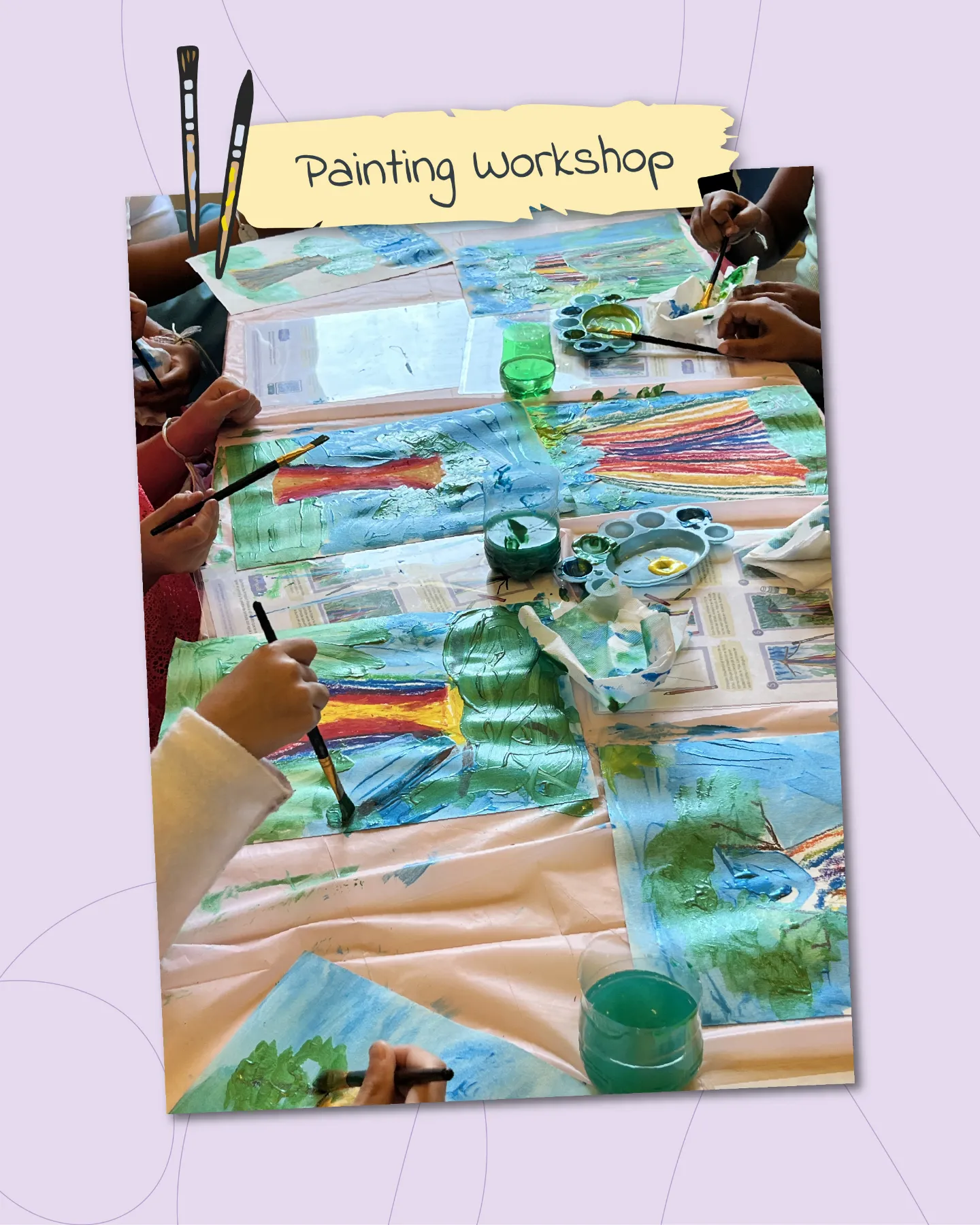 A lively painting workshop scene on a soft purple background with swirling decorative lines. A close-up view of a pink-covered table bustling with activity: multiple hands, including one in a white sleeve and another in red lace, paint on large white canvases depicting lush green trees with rainbow trunks against blue skies and grassy fields. Scattered supplies include green and blue paint palettes, brushes dipping into teal water cups, colorful yarn strips, and instructional sheets. A yellow torn-paper banner overhead reads "Painting workshop" flanked by black brush icons, capturing collaborative joy and artistic expression.