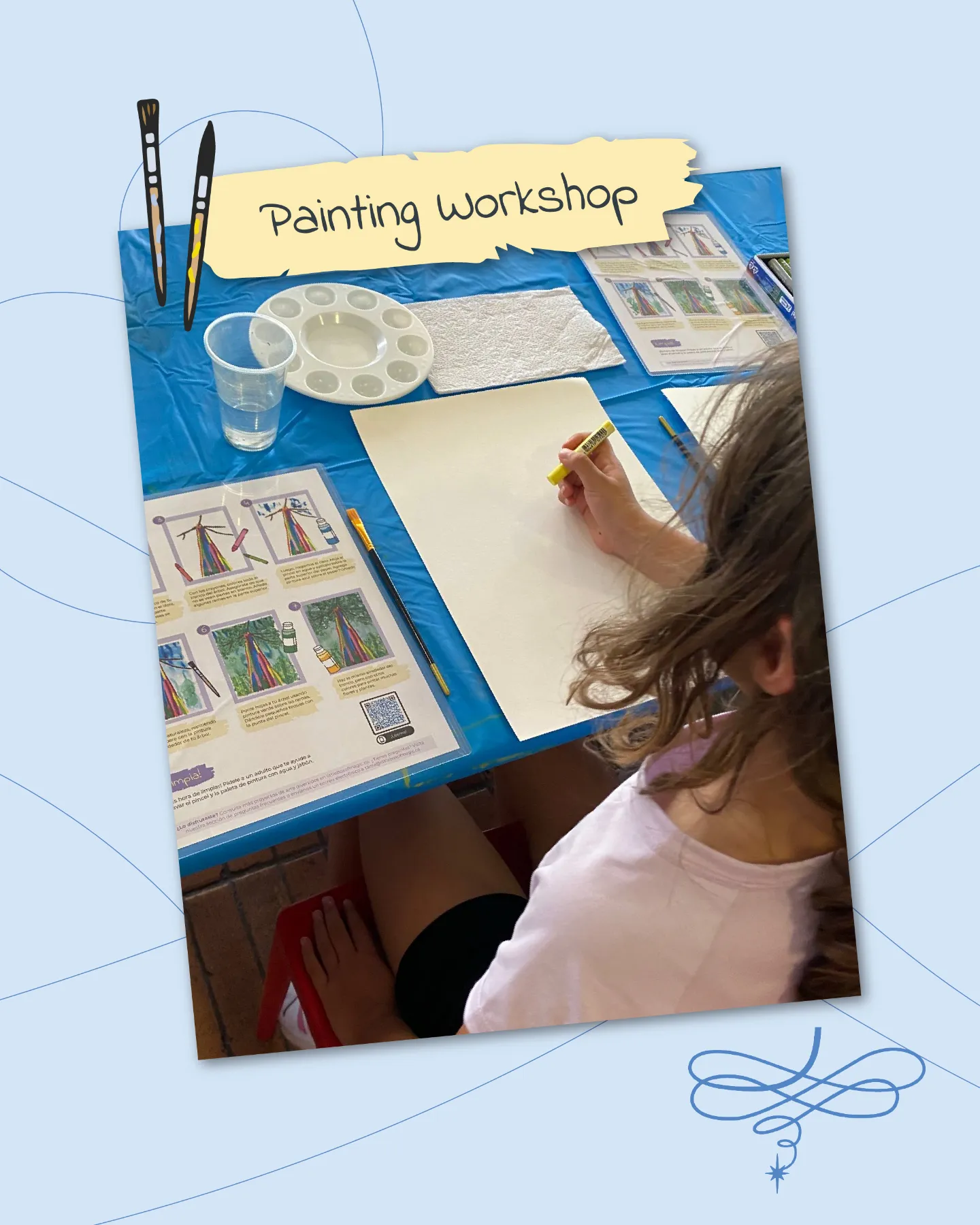 A cozy painting workshop scene on a light blue background with swirling decorative lines. A young girl with long wavy brown hair, wearing a light pink T-shirt and black shorts, sits at a blue-covered table, intently sketching on a blank white sheet with a yellow pencil. Nearby art supplies include a clear plastic cup of water, an empty white paint palette, a brown brush, instructional worksheets depicting step-by-step rainbow tree and umbrella paintings in vibrant colors, and a stack of white paper. A yellow torn-paper banner reads "Painting Workshop" with black brush icons. A red chair and wooden floor are visible in the corner, evoking creativity and focus.